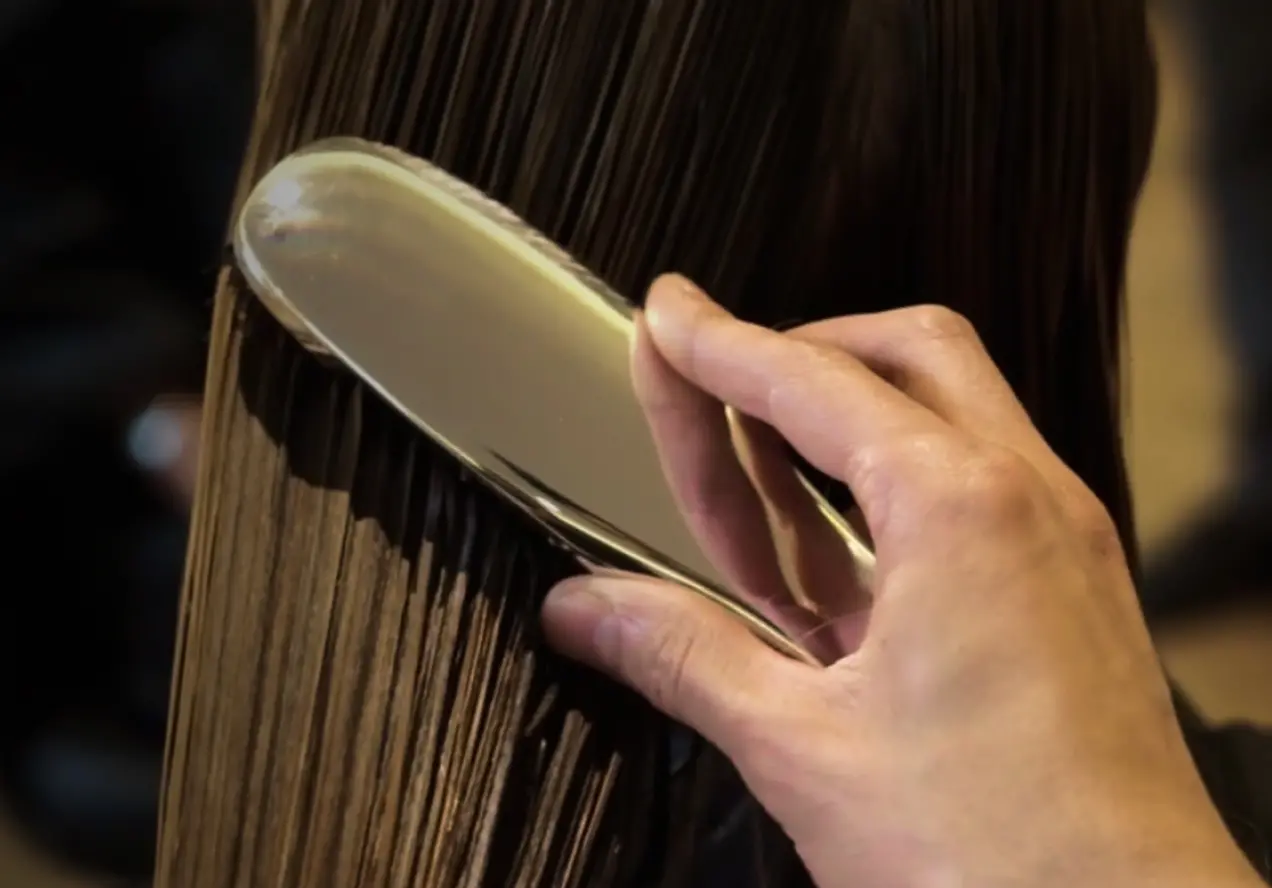 Brushing hair with a brush